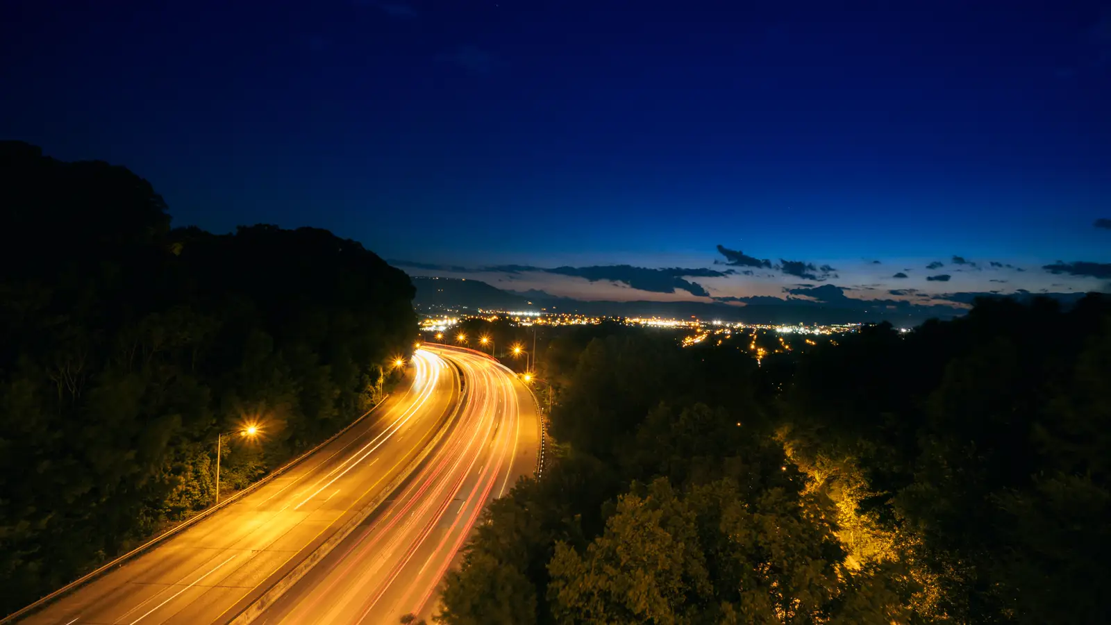 Nighttime highway with long-exposure vehicle light trails