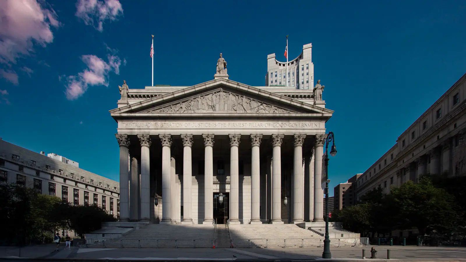 Courthouse exterior with columns under a blue sky